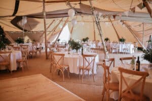 Round Tables and chairs inside Covered in Style Tipi